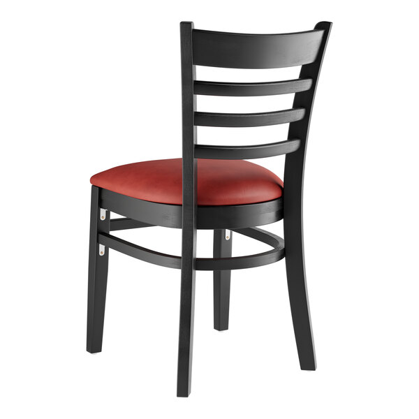A Lancaster Table & Seating black wood ladder back chair with burgundy vinyl seat.