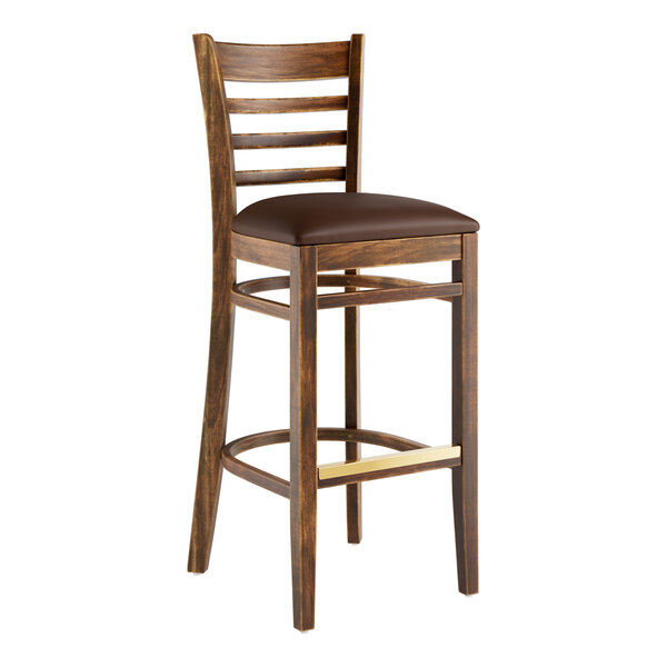A Lancaster Table & Seating wooden bar stool with dark brown vinyl seat.
