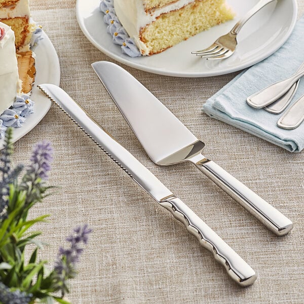 A cake with a silver knife and fork on a table.