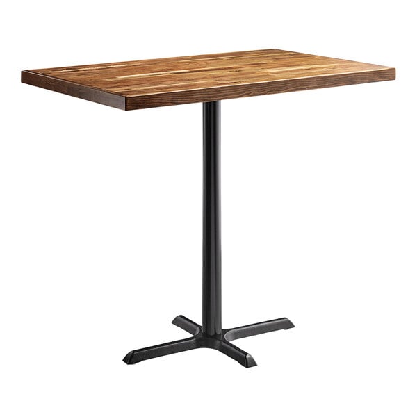A Lancaster Table & Seating rectangular wooden table with a black cast iron base.