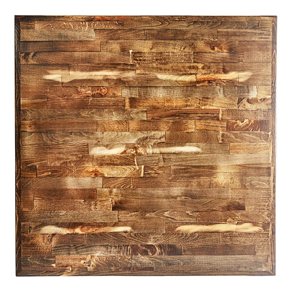 A Lancaster Table & Seating bar height wood table with a vintage finish and cast iron base.