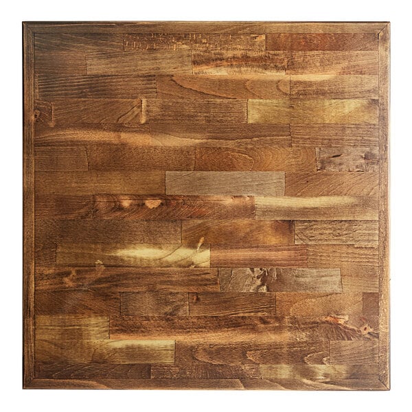 A Lancaster Table & Seating square wood table top with a vintage finish on a cast iron base.