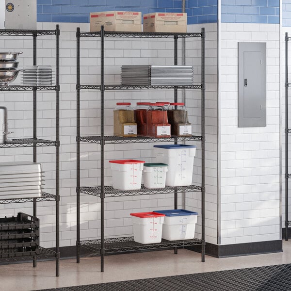 A black epoxy 5-shelf wire shelving unit with 72-inch posts, used for storage in a commercial kitchen setting.