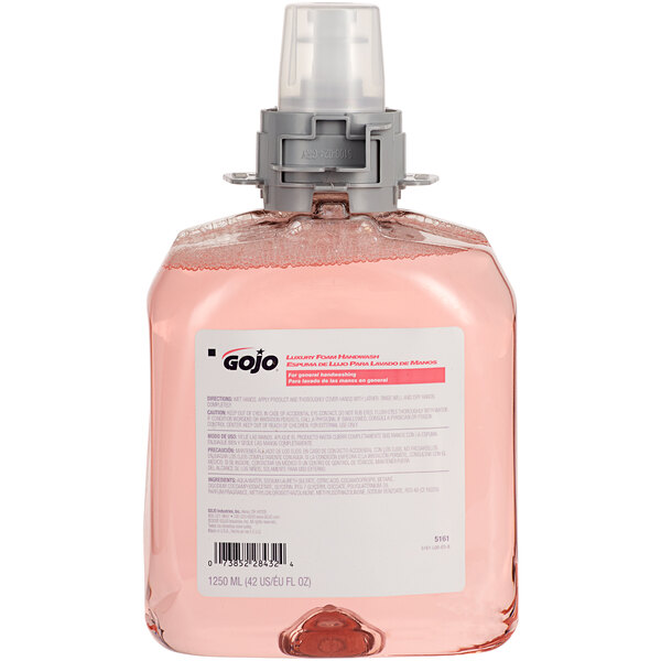 A white bottle of GOJO cranberry liquid hand soap with a pink label and pink liquid.