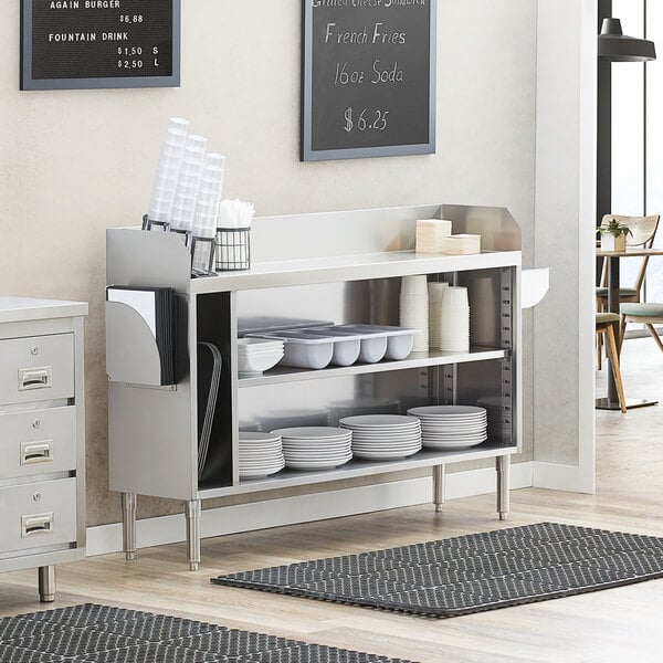 A Regency stainless steel waitress station on a white counter.