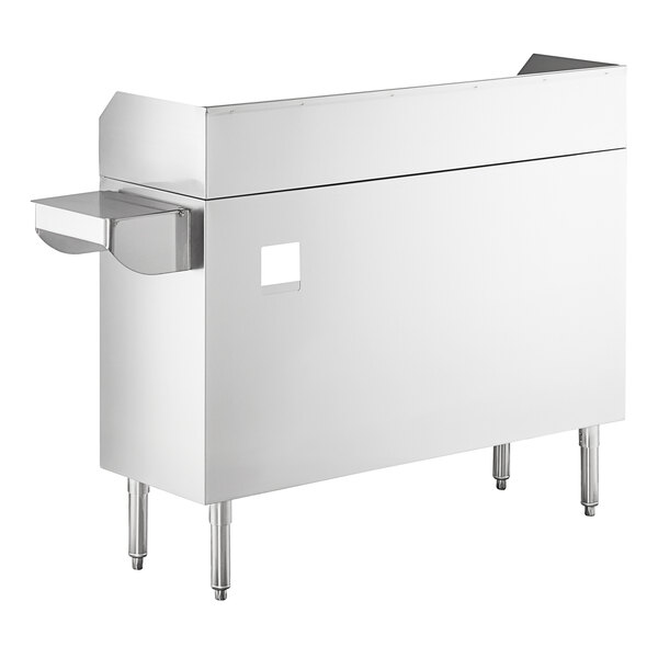 A stainless steel station with four legs, a raised back and sides, a small sink bowl, and a pan holder attachment on the left side.