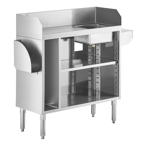 A stainless steel station with a sink bowl, open shelving, and side pan holders.