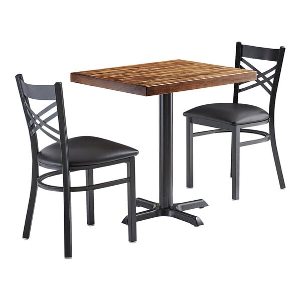A brown wood rectangular table with two black wood chairs.