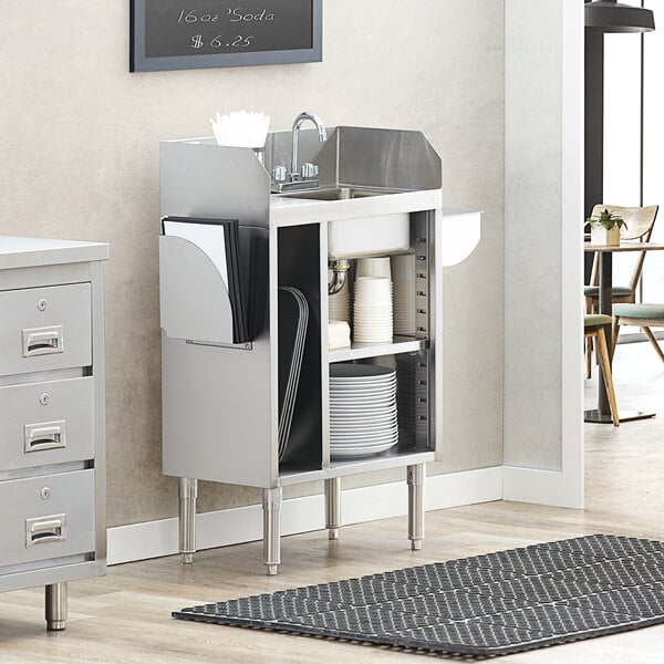 A Regency stainless steel waitress station with a sink in a cabinet.