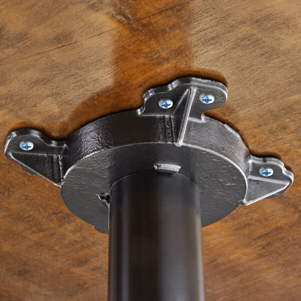 A Lancaster Table & Seating butcher block table top with blue screws.