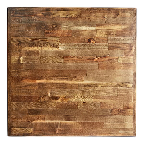 A Lancaster Table & Seating butcher block table with black chairs.