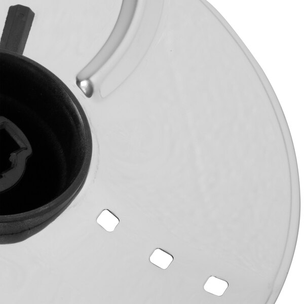 A close-up of a silver Waring whipping disc with a black center and circular hole.