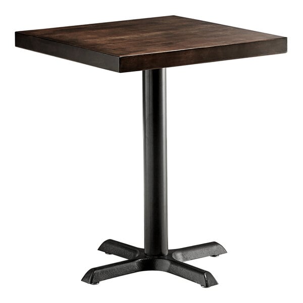 A Lancaster Table & Seating square table with a wooden butcher block top and black base plate.