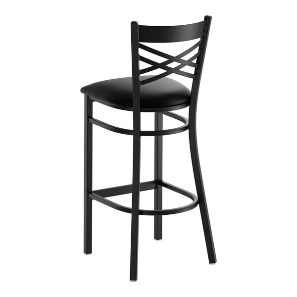 A black metal bar stool with a cross back design and a cushioned seat.