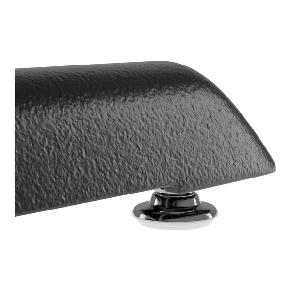 A close-up view of a textured black table edge with a shiny metal base.