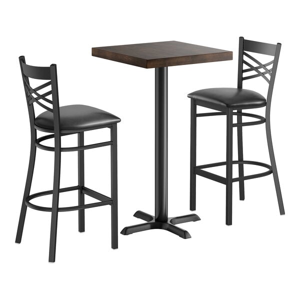 A 24-inch square bar height wood butcher block table with an espresso finish, accompanied by two black cross back chairs.