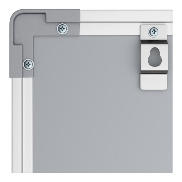 A close-up of the corner of a wall-mount magnetic chalkboard with an aluminum frame and mounting hardware.