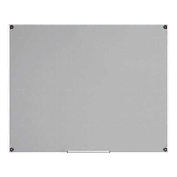 A large, frameless, frosted glass dry erase board mounted on a wall.