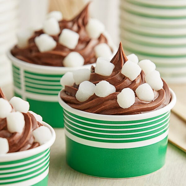 A close up of a cupcake with chocolate and white mini mochi rice cakes on top.