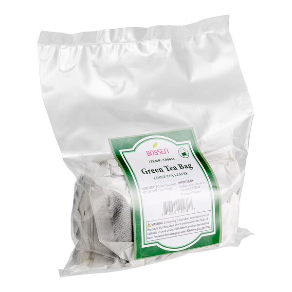 A clear plastic bag containing multiple large green tea bags labeled as loose leaf tea by Bossen.