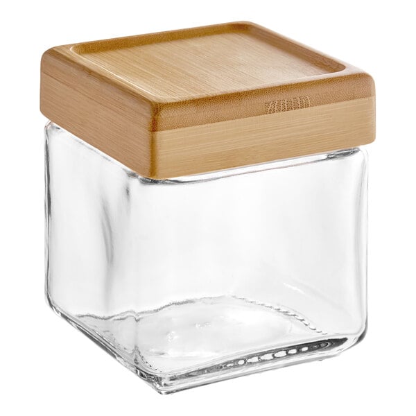 An Anchor Hocking square glass jar with a wooden lid.