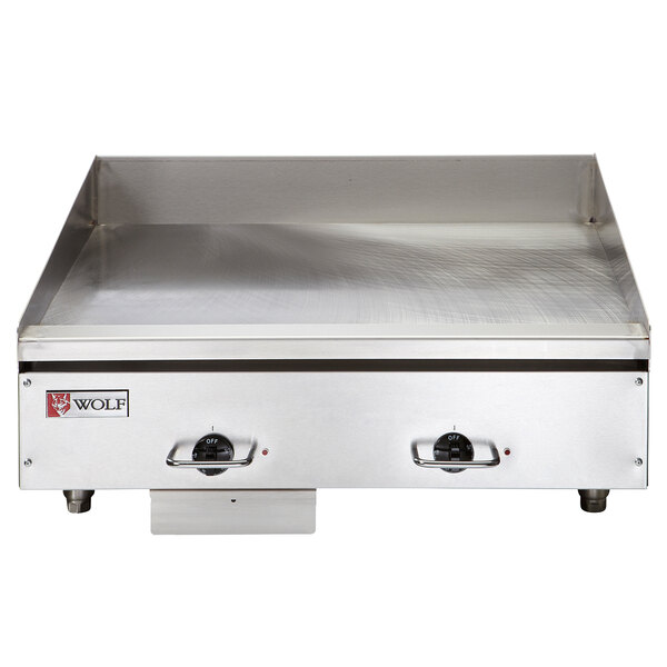 A close-up of a Wolf stainless steel electric countertop griddle.