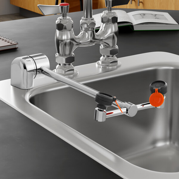 A right hand deck mounted eyewash station with a 90 degree swing down arm installed on a sink.
