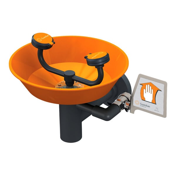 A wall mounted Guardian Equipment eye and face wash station with an orange and black bowl and stainless steel parts.