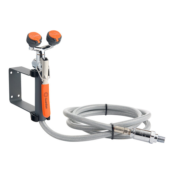 A wall mounted eyewash station with a drench hose and backflow preventer.