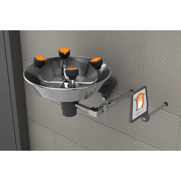A Guardian Equipment wall mounted eye and face wash station with a stainless steel bowl and orange knobs.