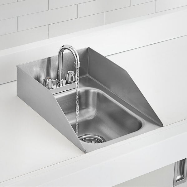 A stainless steel one compartment drop-in sink with a gooseneck faucet and side splashes.