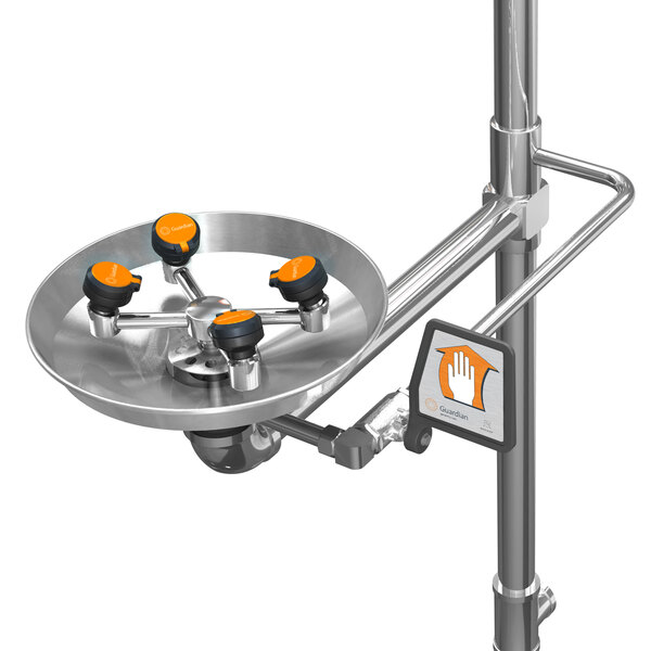 A polished chrome safety station with orange and black accents and a stainless steel shower head.