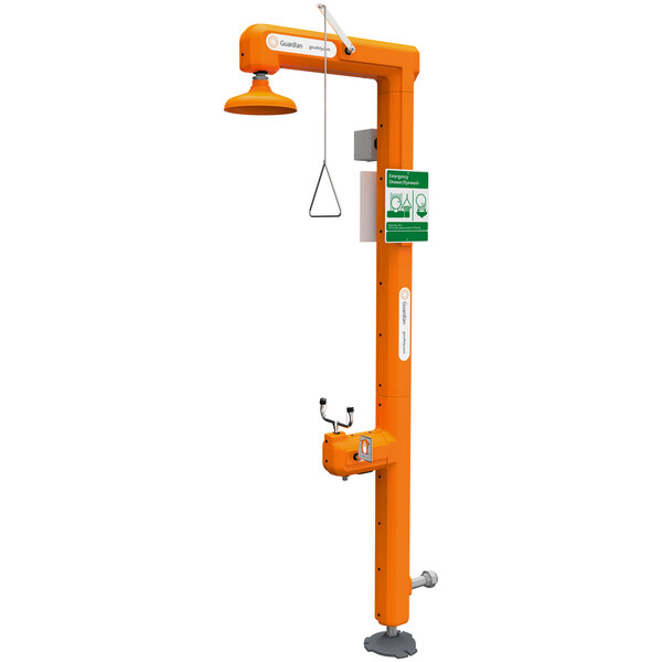 An orange Guardian Equipment heated safety station with a green sign and green handle.