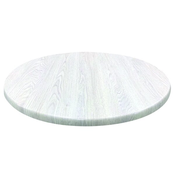 A white round table top with a white wood surface.