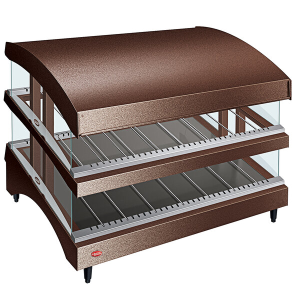 A brown metal Hatco countertop warmer with three slanted shelves in a glass display case.