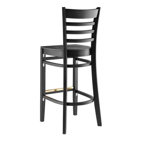 A black Lancaster Table & Seating wood ladder back bar stool with a black seat.