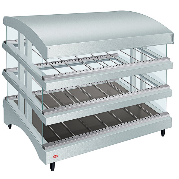 A Hatco heated glass display case with three slanted shelves inside.