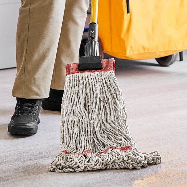 A person using a Choice Natural Cotton Looped End Wet Mop Head to clean a floor.