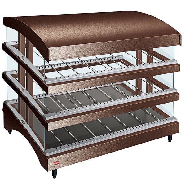 A copper and gold metal Hatco countertop warmer with three slanted glass shelves.