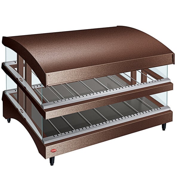 A brown Hatco countertop display warmer with slanted heated glass shelves.
