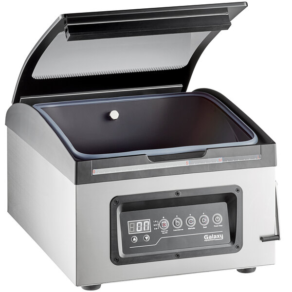 A Galaxy vacuum packaging machine with the lid open on a counter.