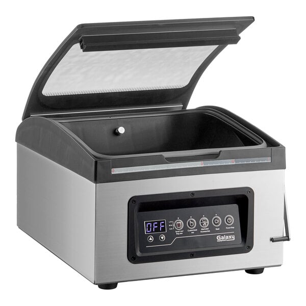 A stainless steel chamber vacuum packing machine with a digital control panel and an open transparent lid.