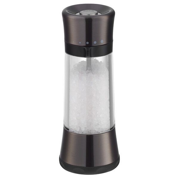An OXO Good Grips salt mill with a glass container and a black lid.