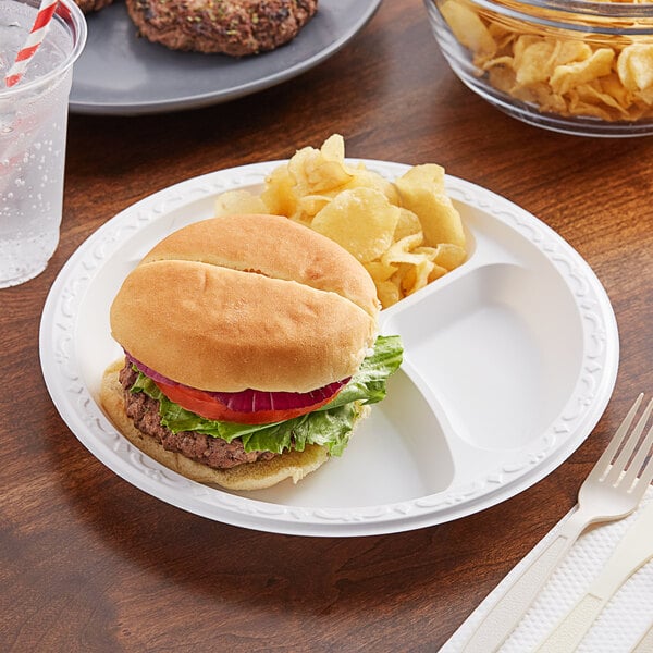 A plate of a burger and potato wedges on an Ecopax 3-compartment plate.