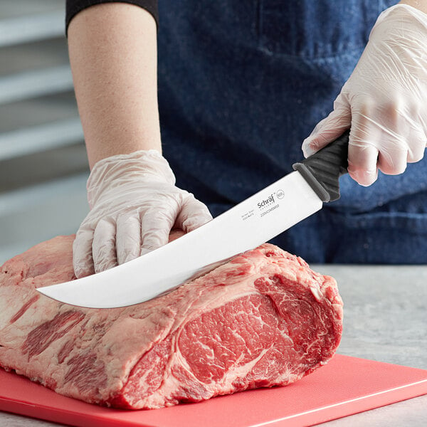 Person using a cimeter knife to create steak cuts