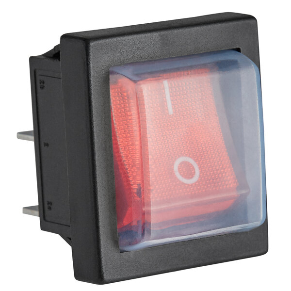 A black and red push button switch with a white circle on the red button.