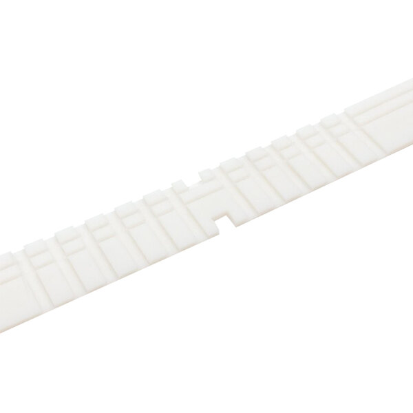 A close-up of a white rectangular hardboard strip with small squares.