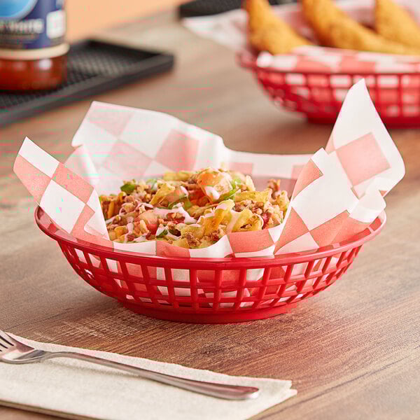 A red GET round plastic fast food basket filled with food on a table in a pizza parlor.