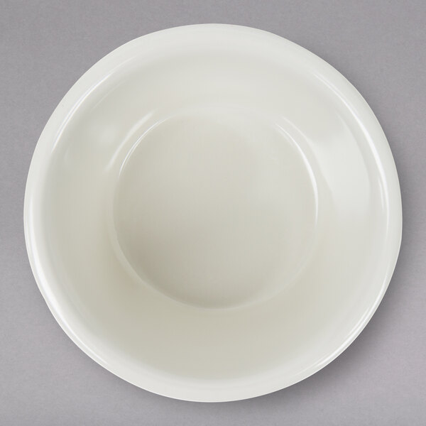 A white Thunder Group melamine ramekin on a gray surface.