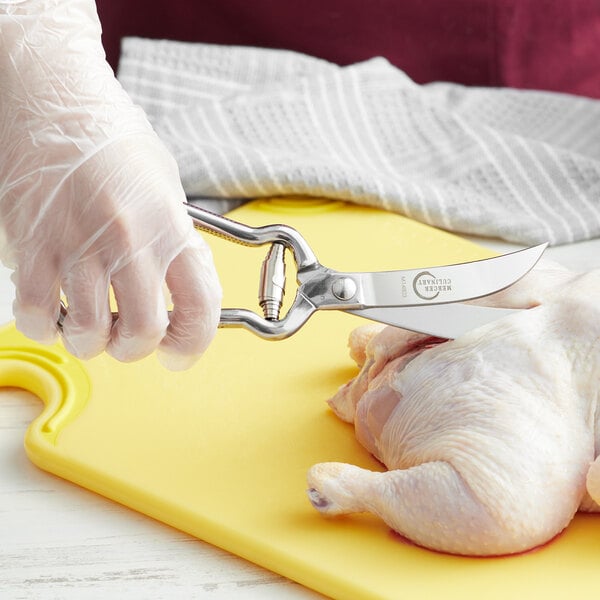 a person cutting a chicken